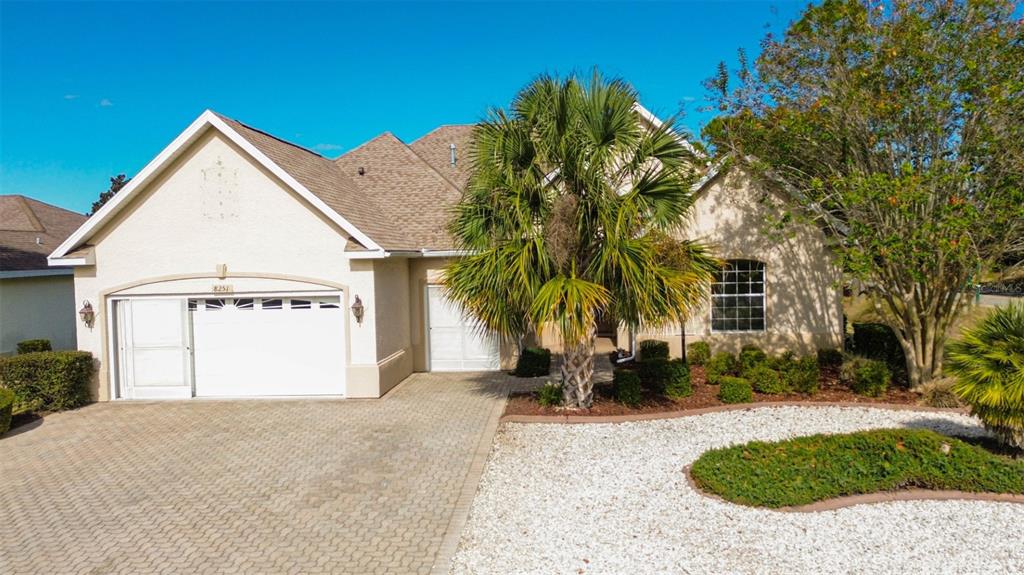 8251 Southwest 84th Place Road Ocala, FL 34481 - Photo 2 of 38 a front view of a house with a yard