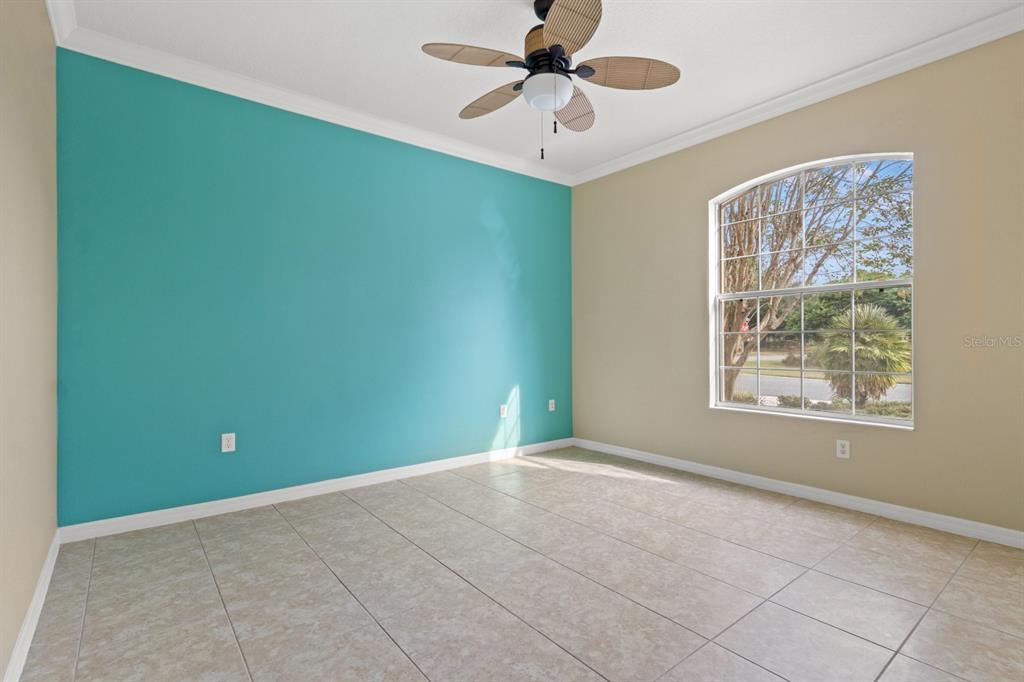 8251 Southwest 84th Place Road Ocala, FL 34481 - Photo 23 of 38 a view of an empty room with window and chandelier fan