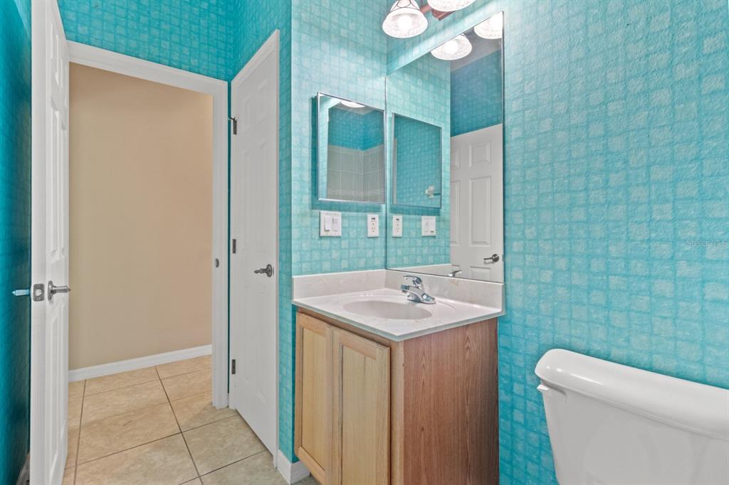 8251 Southwest 84th Place Road Ocala, FL 34481 - Photo 24 of 38 a bathroom with a toilet a sink and mirror