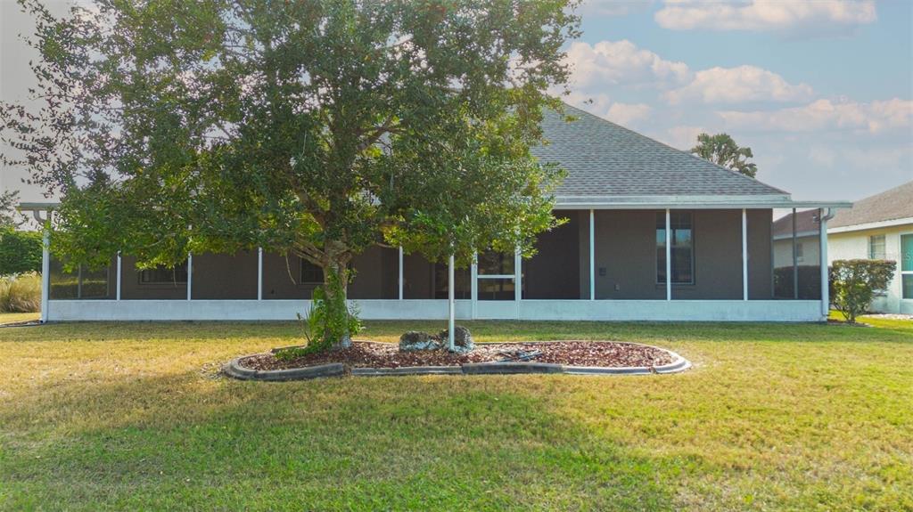 8251 Southwest 84th Place Road Ocala, FL 34481 - Photo 34 of 38 a view of a house with swimming pool and a yard