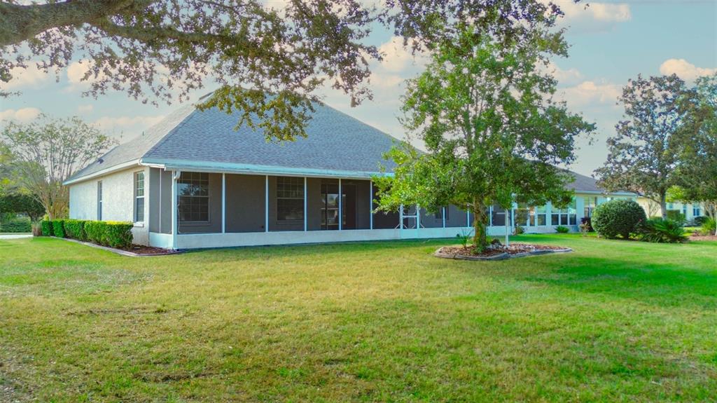 8251 Southwest 84th Place Road Ocala, FL 34481 - Photo 35 of 38 a front view of a house with a yard