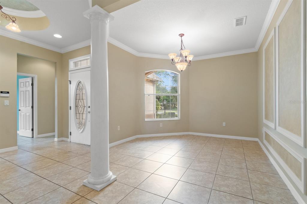 8251 Southwest 84th Place Road Ocala, FL 34481 - Photo 5 of 38 an empty room with kitchen and windows