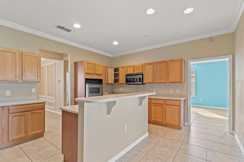 8251 Southwest 84th Place Road Ocala, FL 34481 - Photo 10 of 38 a kitchen with stainless steel appliances granite countertop a refrigerator and a stove top oven