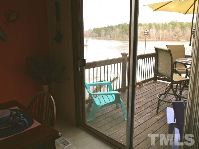 9566 George Ruff Road Bullock, NC 27507 - Photo 13 of 25 a view of a balcony with chair and floor to ceiling window