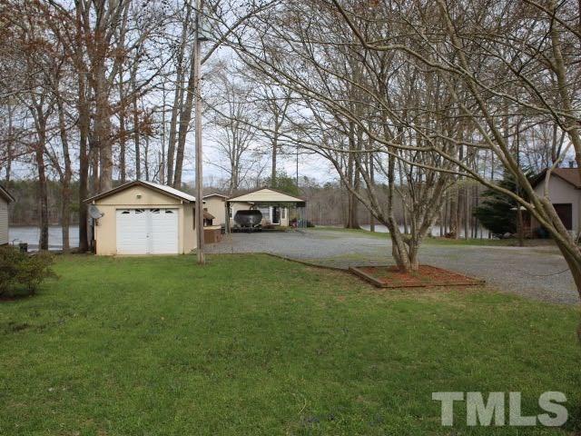 9566 George Ruff Road Bullock, NC 27507 - Photo 19 of 25 a front view of a house with garden
