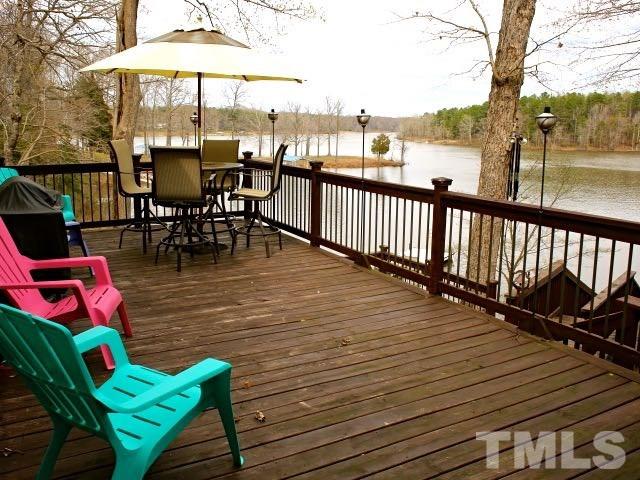 9566 George Ruff Road Bullock, NC 27507 - Photo 3 of 25 an outdoor sitting area with chairs and wooden floor