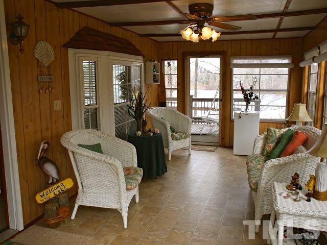9566 George Ruff Road Bullock, NC 27507 - Photo 5 of 25 a living room with furniture a chandelier and a large window