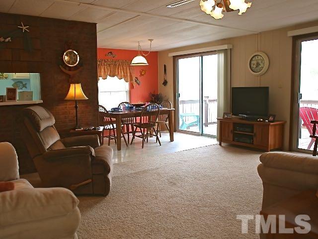 9566 George Ruff Road Bullock, NC 27507 - Photo 6 of 25 a living room with furniture a window and a flat screen tv