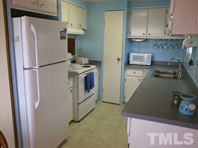 9566 George Ruff Road Bullock, NC 27507 - Photo 8 of 25 a white refrigerator freezer sitting inside of a kitchen