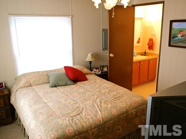 9566 George Ruff Road Bullock, NC 27507 - Photo 9 of 25 a bedroom with a bed and wooden floor