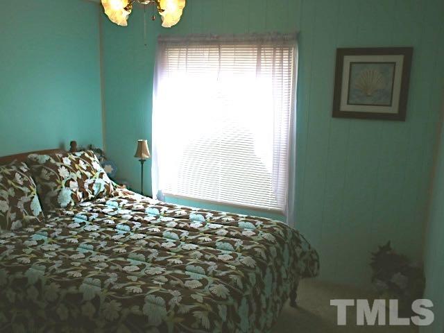 9566 George Ruff Road Bullock, NC 27507 - Photo 10 of 25 a bed sitting in a bedroom next to a window