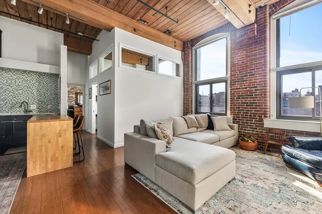 a living room with furniture wooden floor and a table