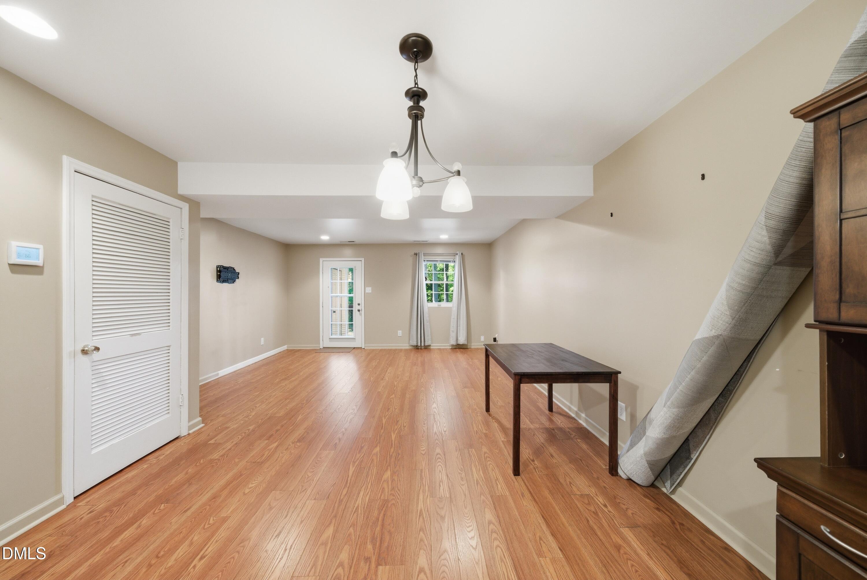 6355 New Market Way Raleigh, NC 27615 - Photo 14 of 30 a view of an empty room with wooden floor and a window