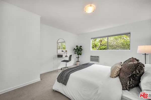 a bedroom with a bed and a lamp