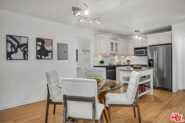 a kitchen with refrigerator cabinets dining table and chairs