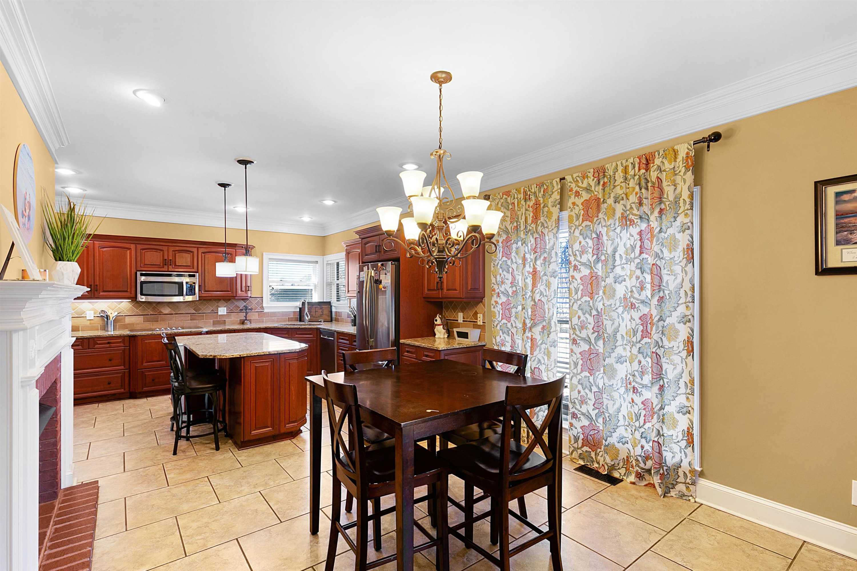 189 Rust Road Bells, TN 38006 - Photo 12 of 33 a dining hall with stainless steel appliances kitchen island granite countertop furniture and a chandelier