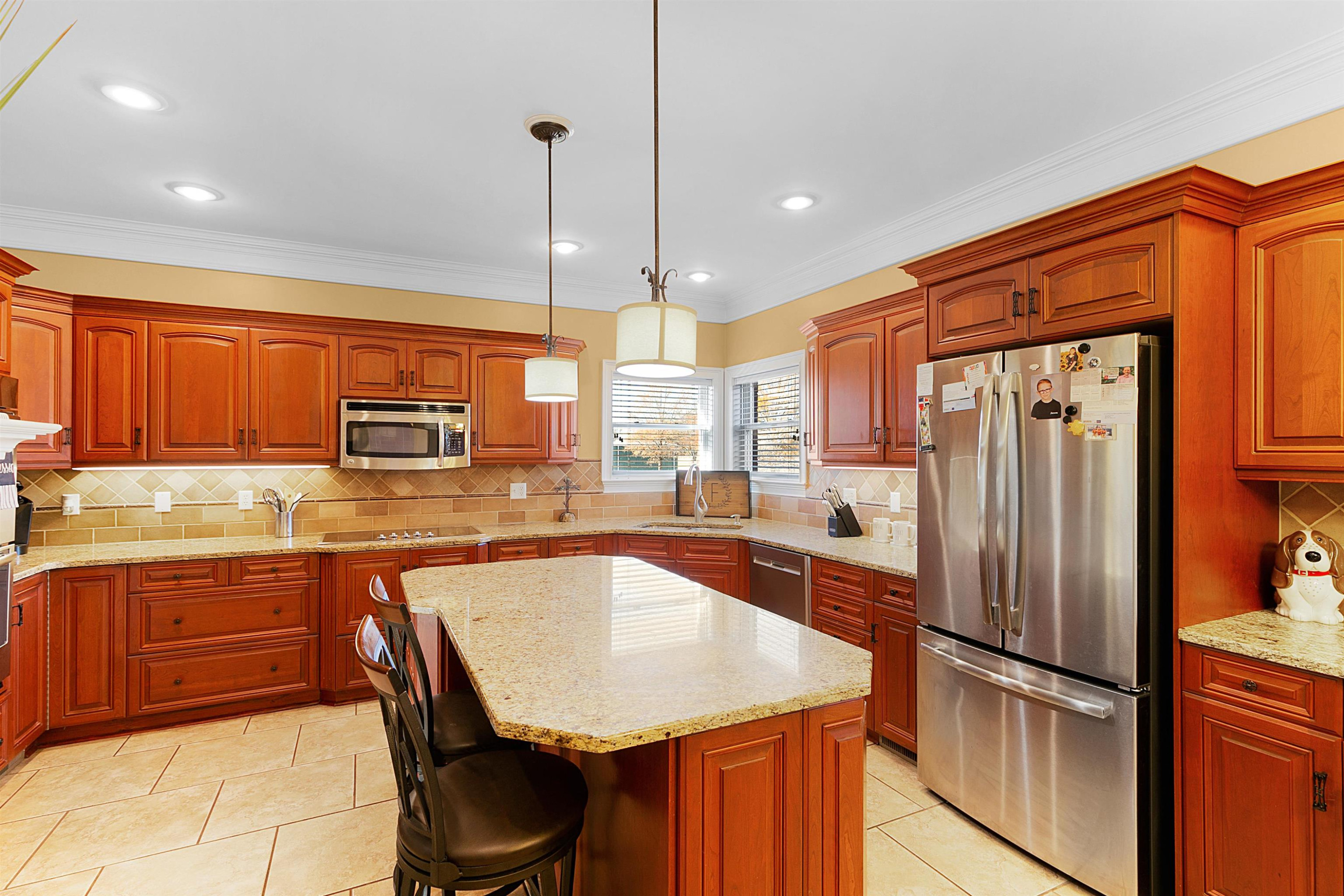 189 Rust Road Bells, TN 38006 - Photo 10 of 33 a kitchen with stainless steel appliances granite countertop a refrigerator a sink dishwasher a stove and white countertops with wooden floor