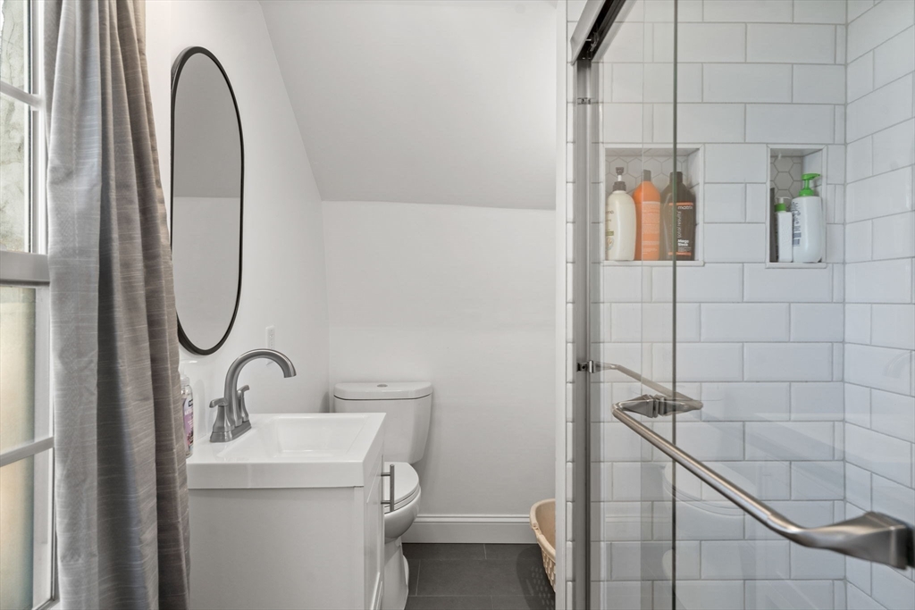 11 Cogswell Road North Reading, MA 01864 - Photo 13 of 29 a bathroom with a sink a toilet and a mirror