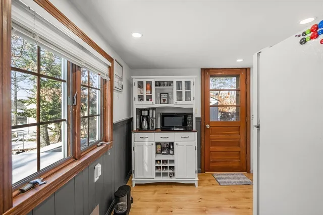 a kitchen with white cabinets and appliances