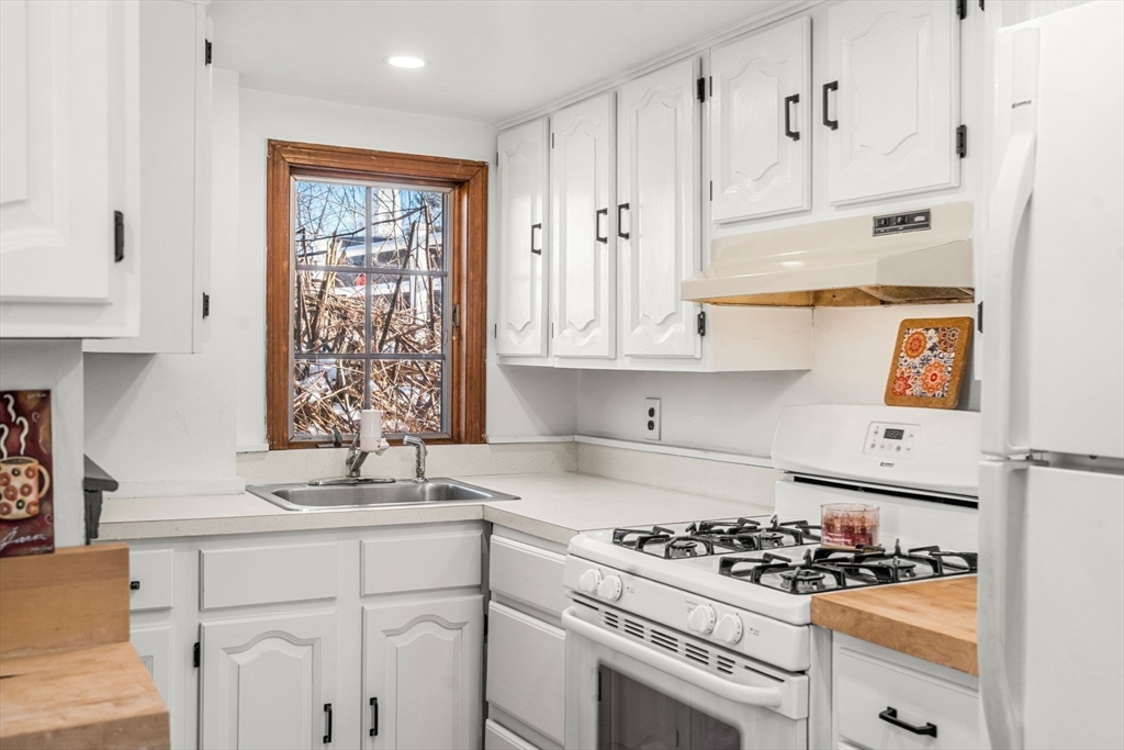 11 Cogswell Road North Reading, MA 01864 - Photo 19 of 29 a kitchen with white cabinets and appliances
