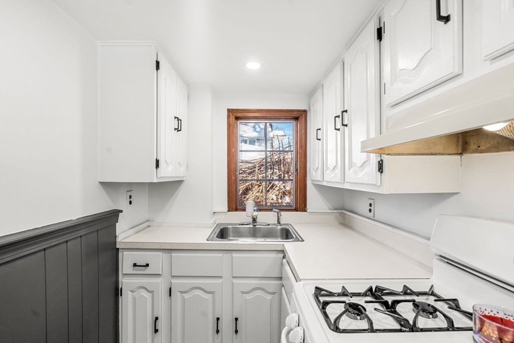 11 Cogswell Road North Reading, MA 01864 - Photo 20 of 29 a kitchen with stainless steel appliances a sink a stove and white cabinets