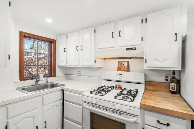 a kitchen with stainless steel appliances granite countertop a stove and a refrigerator