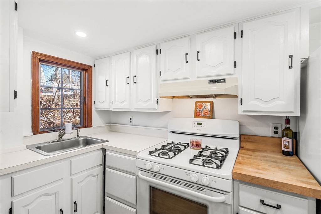 11 Cogswell Road North Reading, MA 01864 - Photo 21 of 29 a kitchen with white cabinets sink and white appliances