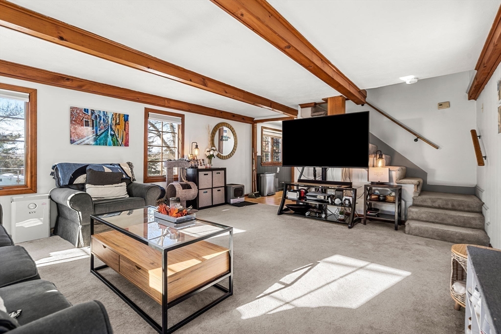11 Cogswell Road North Reading, MA 01864 - Photo 24 of 29 a living room with furniture and a flat screen tv