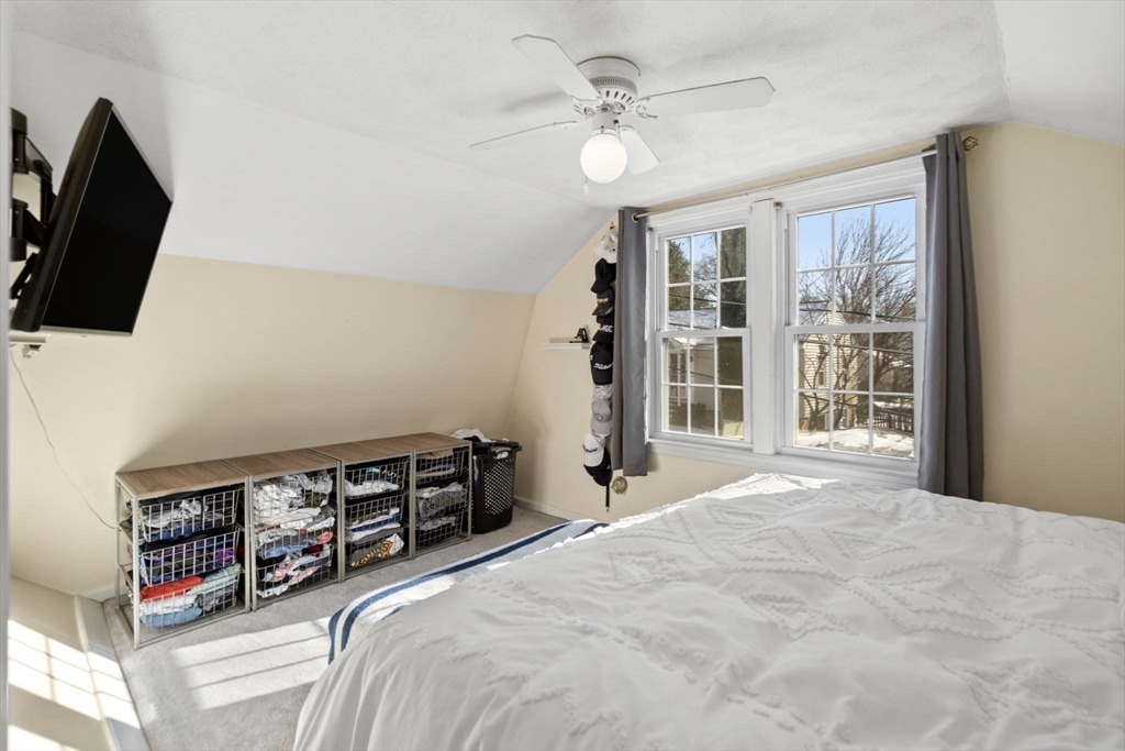 11 Cogswell Road North Reading, MA 01864 - Photo 8 of 29 a bedroom with a bed a flat screen tv and a large window