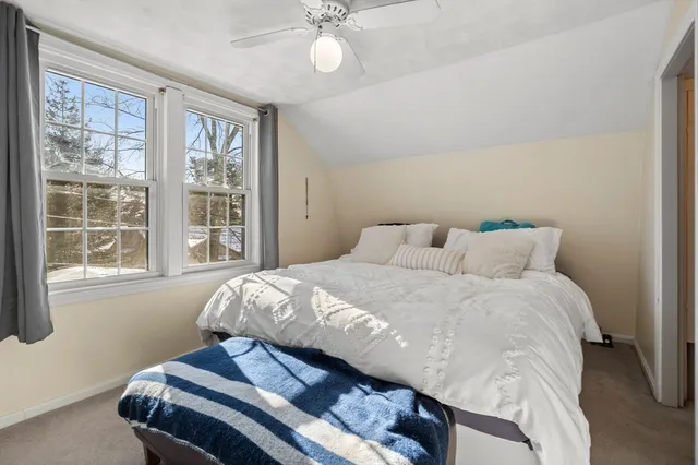 a bedroom with a bed and window