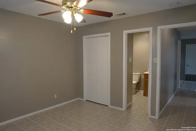 wooden floor in an empty room and a bathroom
