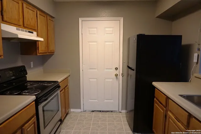 a kitchen with a stove and a refrigerator