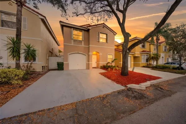 a front view of a house with a yard and garage