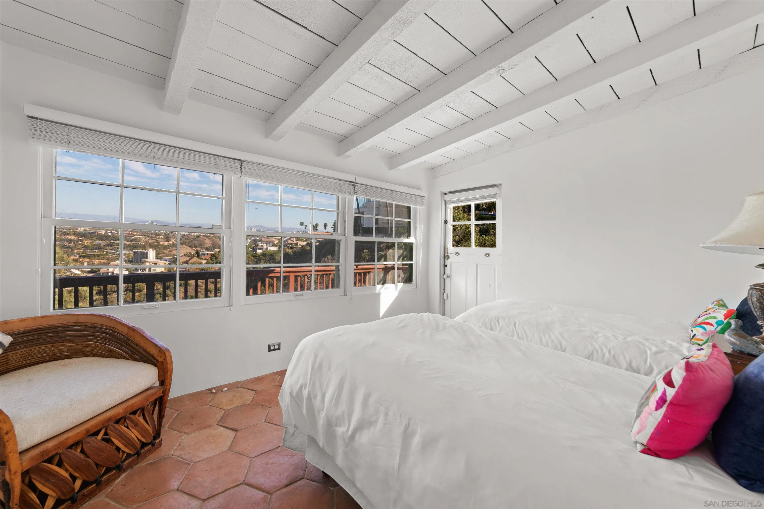 7477 Hillside Drive La Jolla, CA 92037 - Photo 11 of 25 a large bed sitting in a bedroom next to a window