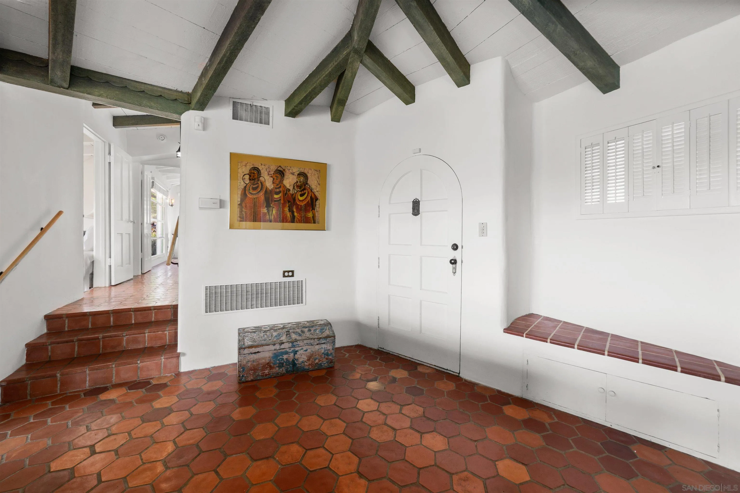 7477 Hillside Drive La Jolla, CA 92037 - Photo 3 of 25 a hallway with stairs and a furniture