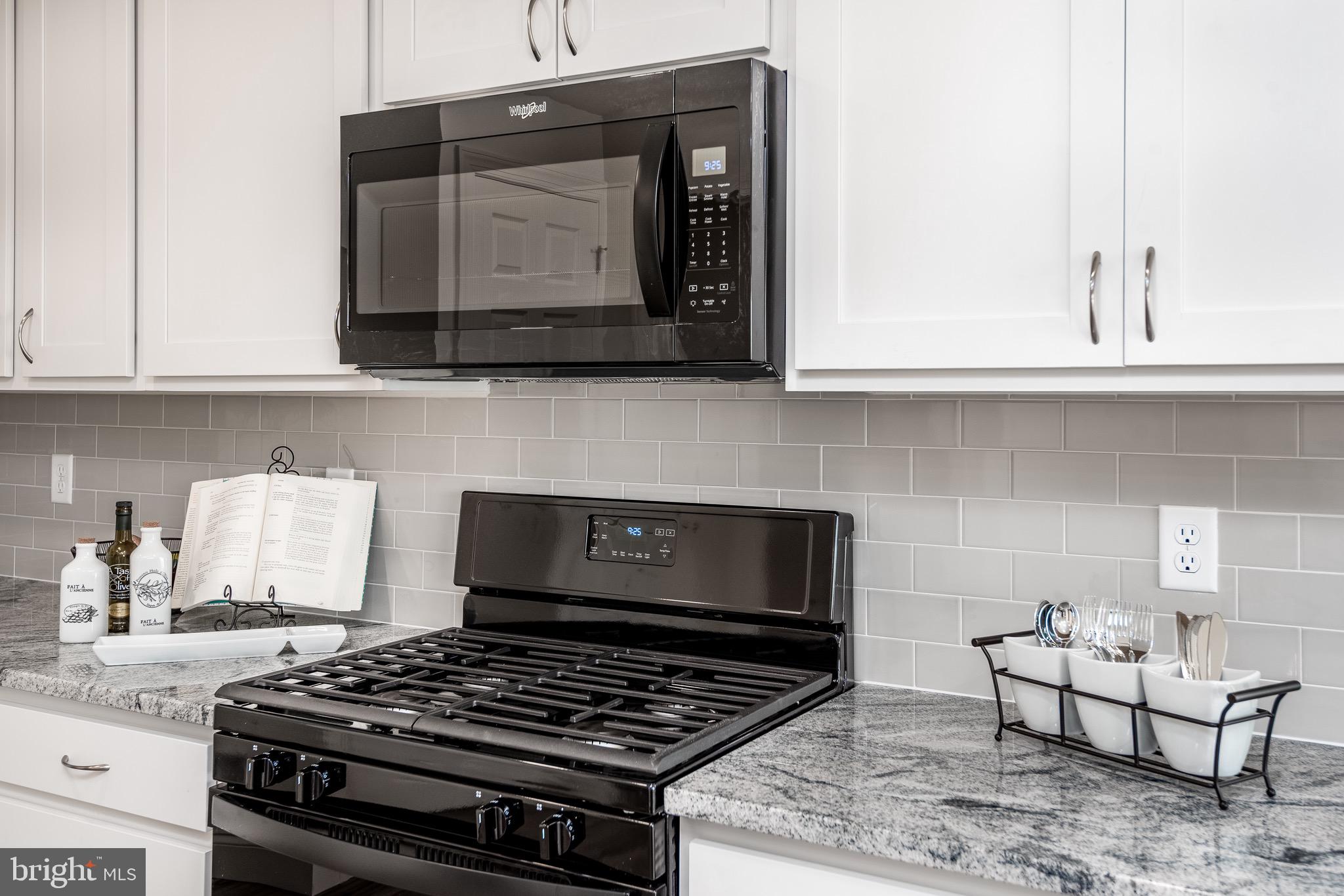217 Eagle Road Newtown, PA 18940 - Photo 8 of 41 a kitchen with granite countertop a stove and a white cabinets