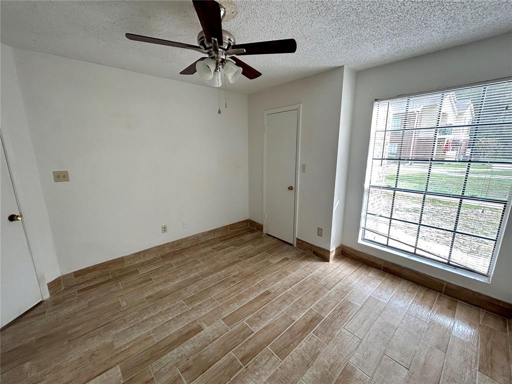 8758 Mallard Reserve Drive, Unit 102 Tampa, FL 33614 - Photo 12 of 17 wooden floor in an empty room with a window