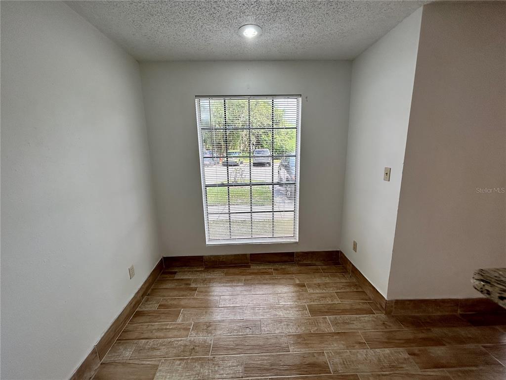 8758 Mallard Reserve Drive, Unit 102 Tampa, FL 33614 - Photo 6 of 17 wooden floor in an empty room with a window