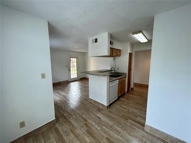 a kitchen with granite countertop a stove and a refrigerator