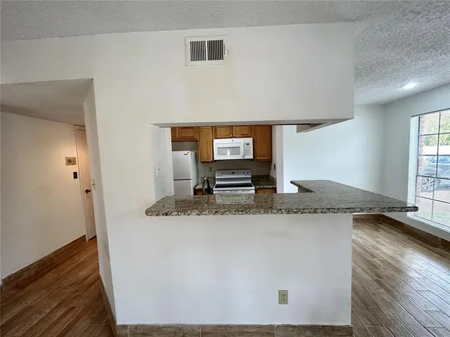 a kitchen with granite countertop a sink and a granite counter tops