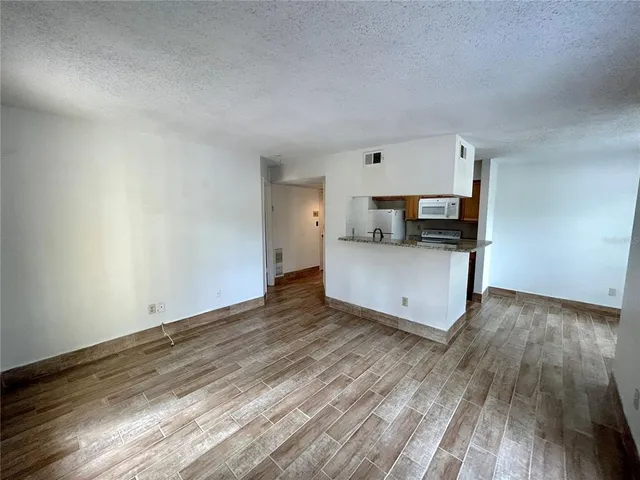a view of kitchen and wooden floor