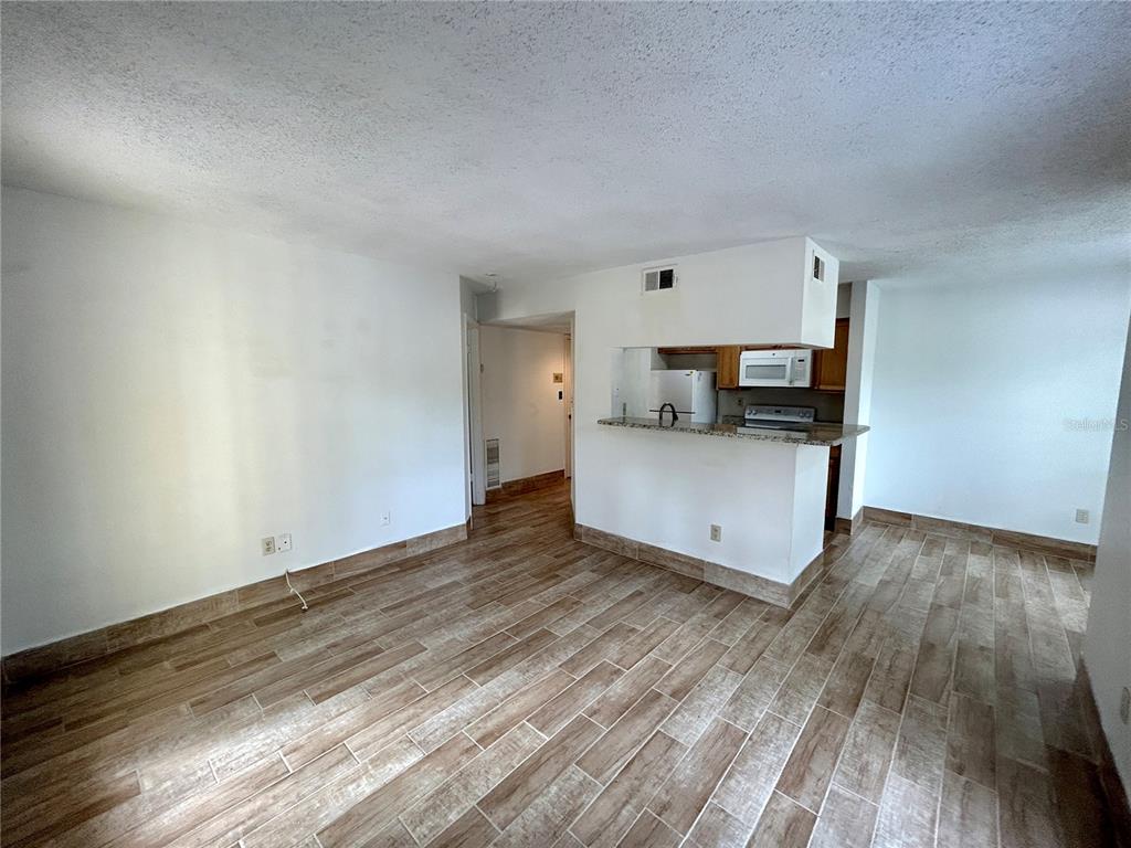 8758 Mallard Reserve Drive, Unit 102 Tampa, FL 33614 - Photo 9 of 17 a view of kitchen and wooden floor