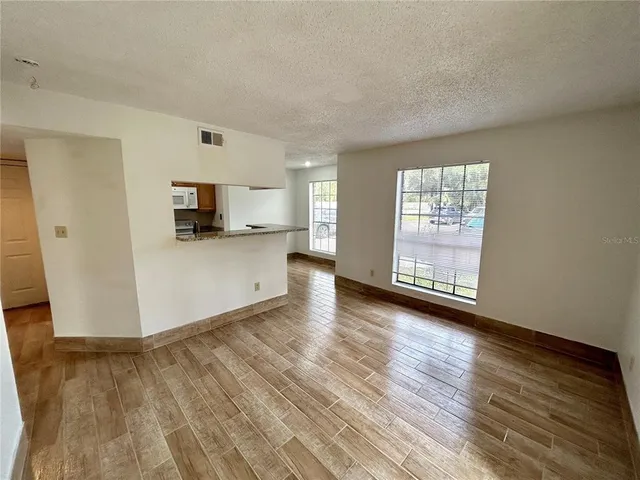 a view of a kitchen with microwave and cabinets