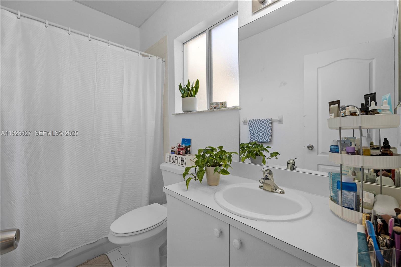 8525 Southwest 214th Terrace Cutler Bay, FL 33189 - Photo 13 of 35 a bathroom with a sink toilet and mirror