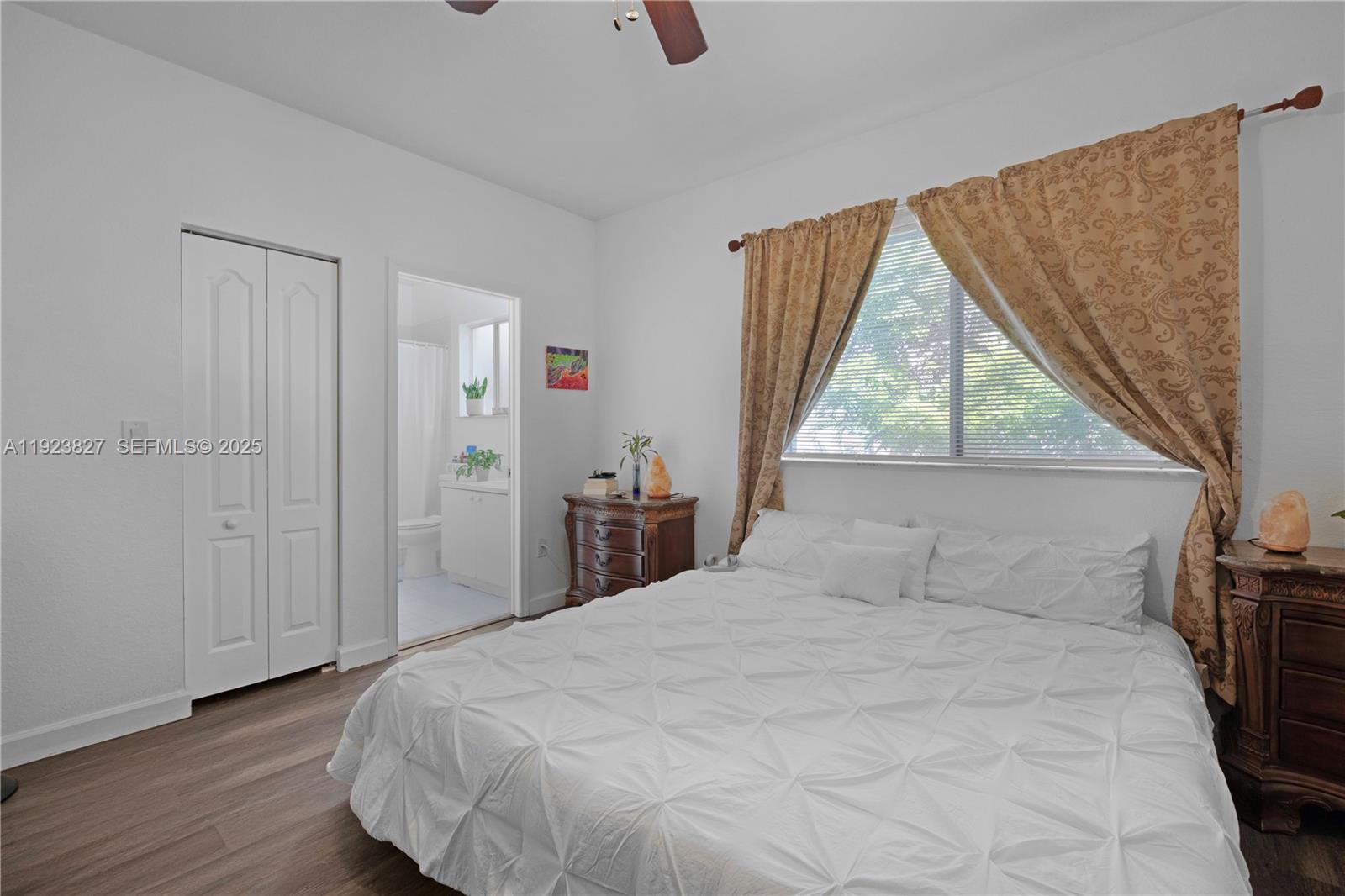8525 Southwest 214th Terrace Cutler Bay, FL 33189 - Photo 15 of 35 a bedroom with a bed and a large window