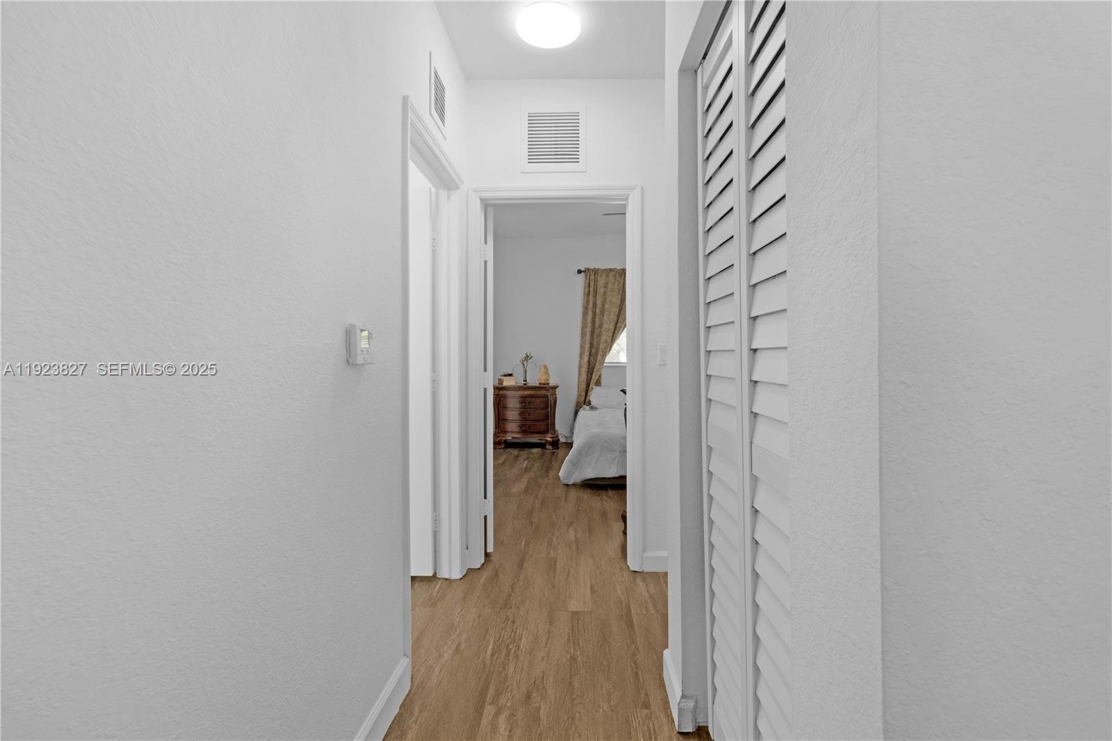 8525 Southwest 214th Terrace Cutler Bay, FL 33189 - Photo 17 of 35 a view of a bedroom from a hallway
