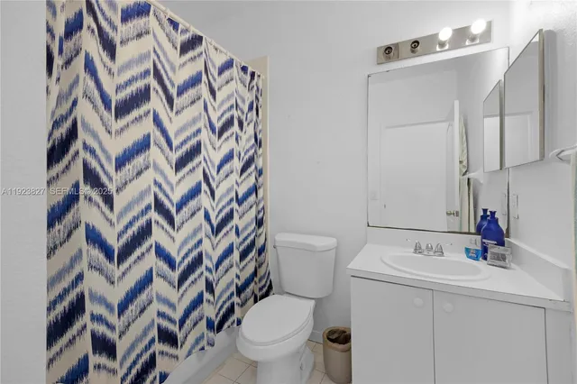 a bathroom with a sink and mirror with toilet