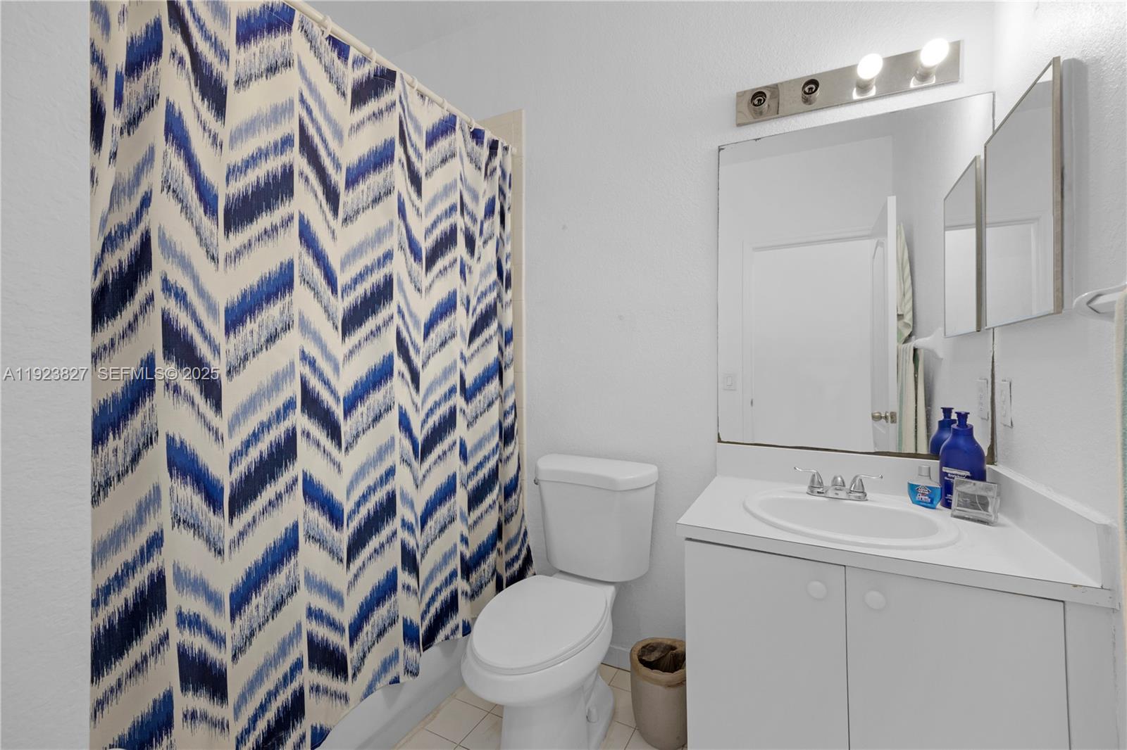8525 Southwest 214th Terrace Cutler Bay, FL 33189 - Photo 18 of 35 a bathroom with a sink and mirror with toilet