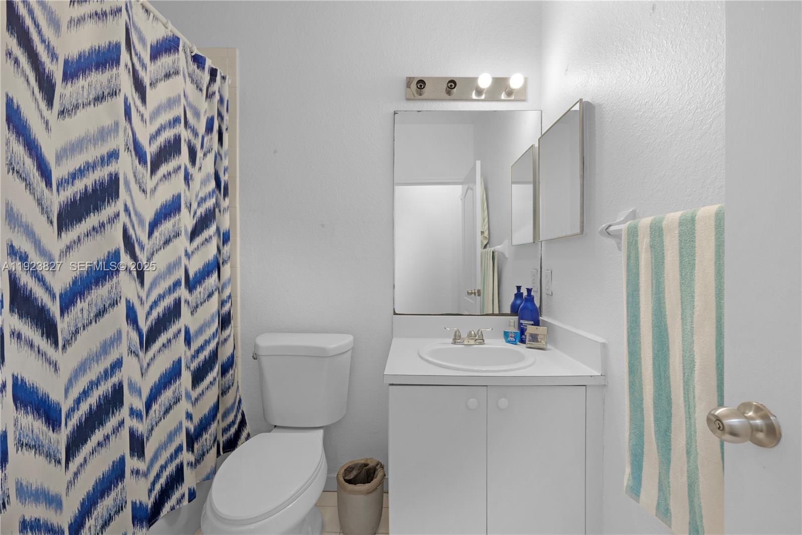 8525 Southwest 214th Terrace Cutler Bay, FL 33189 - Photo 19 of 35 a bathroom with a sink toilet and shower