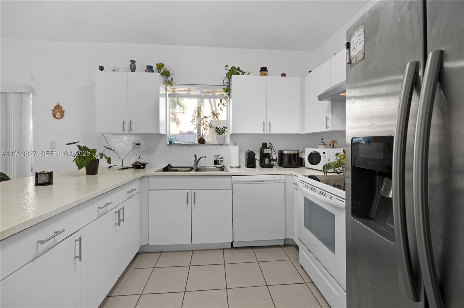 8525 Southwest 214th Terrace Cutler Bay, FL 33189 - Photo 22 of 35 a kitchen with cabinets and appliances